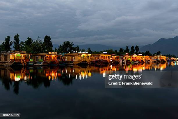 Houseboats for rent, anchored at Dal Lake and illuminated mirrored in the water at night, are the main attraction for Tourists visiting Kashmir..