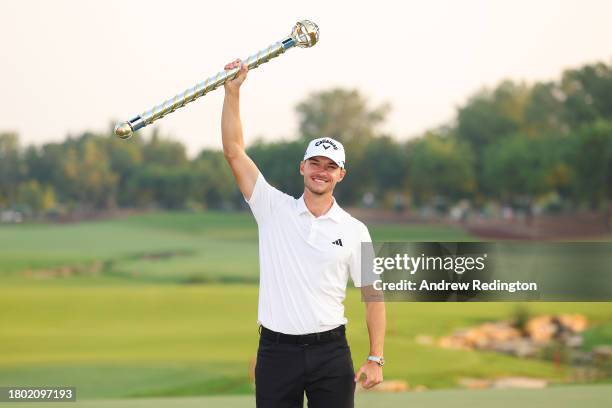 Nicolai Hojgaard of Denmark lifts the DP World Tour Championship trophy on the 18th green during Day Four of the DP World Tour Championship on the...