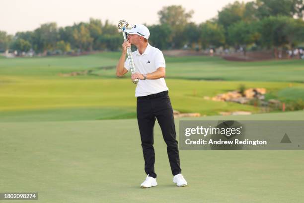 Nicolai Hojgaard of Denmark kisses the DP World Tour Championship trophy on the 18th green during Day Four of the DP World Tour Championship on the...