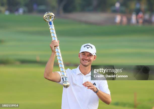 Nicolai Hojgaard of Denmark holds the DP World Tour Championship trophy after his win during the final round on Day Four of the of the DP World Tour...