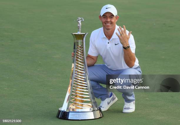 Rory McIlroy of Northern Ireland poses the DP World Tour Race to Dubai trophy which he won for the fifth time this season after the final round on...