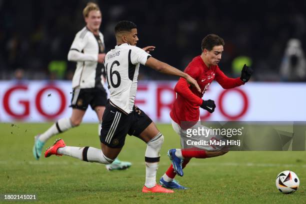 Benjamin Henrichs of Germany battles for possession with Kenan Yildiz of Turkey during an international friendly match between Germany and Turkey at...