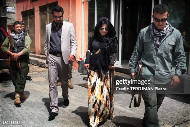 Singer Aryana Sayeed walks in the street on August 17, 2013 in Kabul,Afghanistan. Afghan singer Aryana Sayeed, attends a concert of young Afghans...