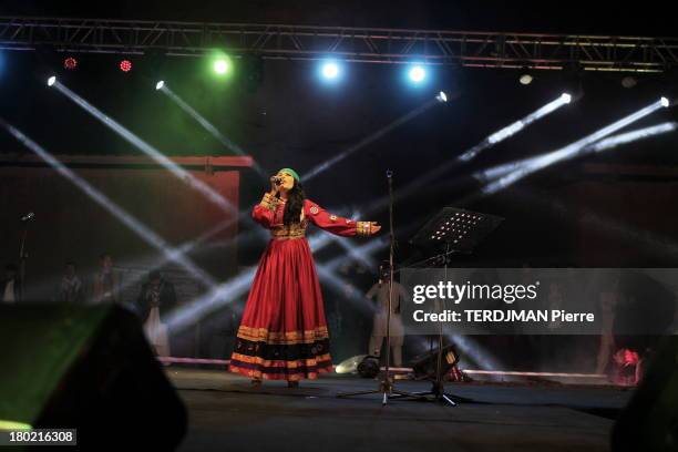 Singer Aryana Sayeed on stage wearing a traditional dress on August 15, 2013 in Bamiyan, Afghanistan. Afghan singer Aryana Sayeed attends a concert...