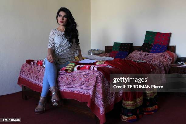 Before the concert, Aryana Sayeed poses in her hotel room on the bed, the traditional dress she will wear on stage on August 15, 2013 in Bamiyan,...