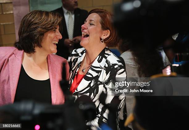 Democratic mayoral candidate Christine Quinn and her wife Kim Catullo embrace before casting their votes in the primary election for New York City...