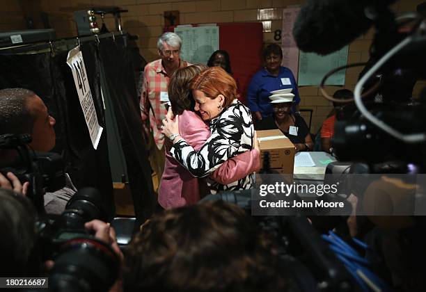 Democratic mayoral candidate Christine Quinn and her wife Kim Catullo embrace after casting their votes in the primary election for New York City...