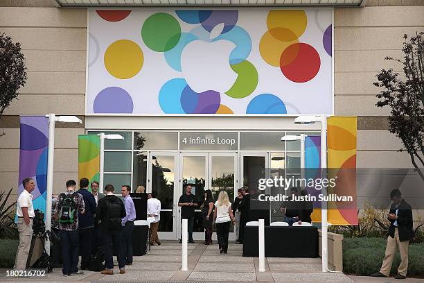 People arrive for an Apple product announcement at the Apple campus on September 10, 2013 in Cupertino, California. The company is expected to launch...