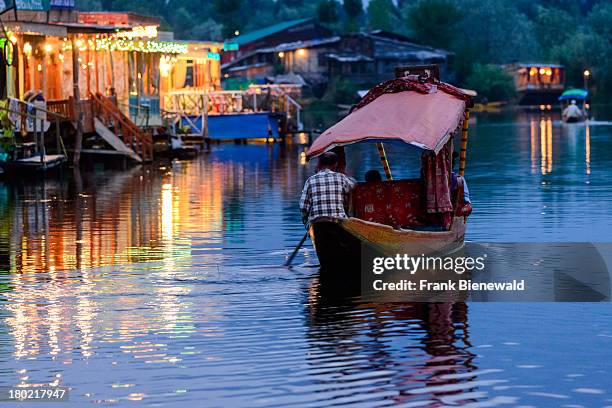 Shikaras are the most common form of transportation for people and goods on Dal Lake. Houseboats for rent are seen in the background..