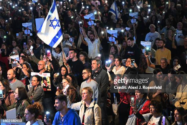 Thousands of people and the families of hostages hold up their mobile phones with the torch on to sing the national anthem during the ‘50 Days of...
