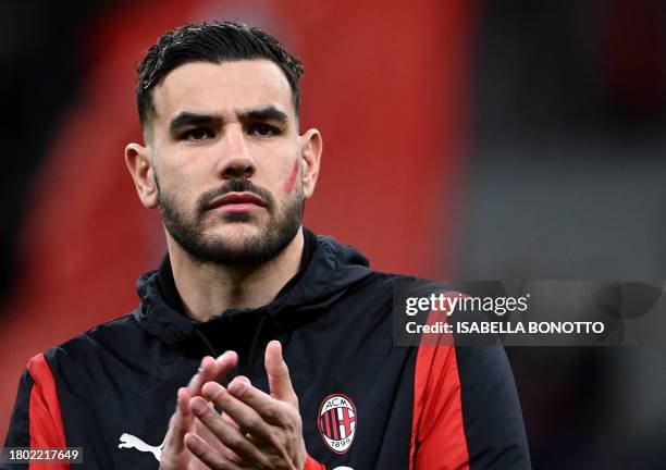 Milan's French defender Theo Hernandez applauds with a red sign on his face in support of the International Day for the Elimination of Violence...