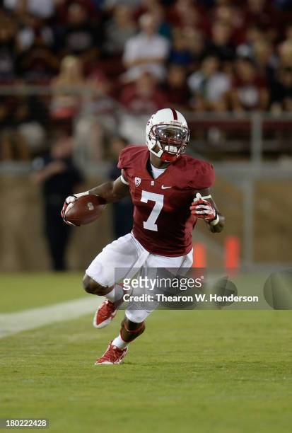 Ty Montgomery of the Stanford Cardinal carries the ball up field after a catch against the San Jose State Spartans at Stanford Stadium on September...