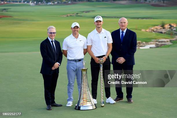 Nicolai Hojgaard of Denmark holds the DP World Tour Championship trophy with Rory McIlroy of Northern Ireland who won the DP World Tour Race to Dubai...