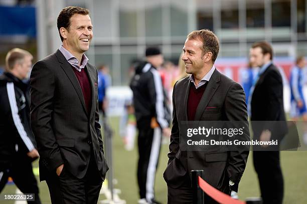 Manager Oliver Bierhoff and assistant coach Hans-Dieter Flick of Germany joke prior to the FIFA 2014 World Cup Qualifier match between Faeroe Islands...