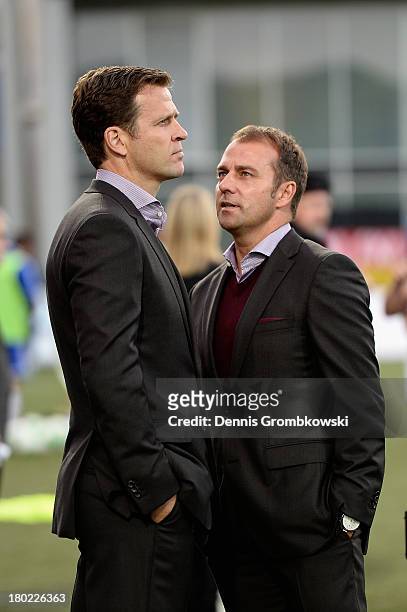 Manager Oliver Bierhoff and assistant coach Hans-Dieter Flick of Germany joke prior to the FIFA 2014 World Cup Qualifier match between Faeroe Islands...