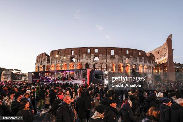 Protesters make their way past the Colosseum during a demonstration against male violence on women in Rome, Italy, on November 25, 2023. Hundred of...
