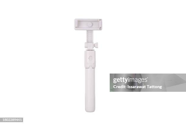 an extensible selfie stick with an adjustable clamp on the end on a white background - selfie stick white background stock-fotos und bilder