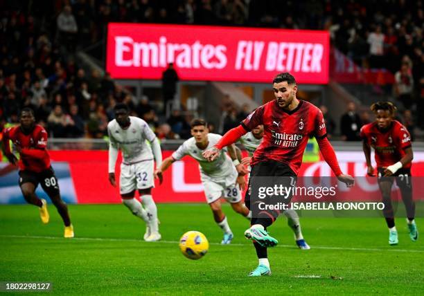 Milan's French defender Theo Hernandez kicks a penalty and scores his team's first goal during the Serie A football match between AC Milan and...