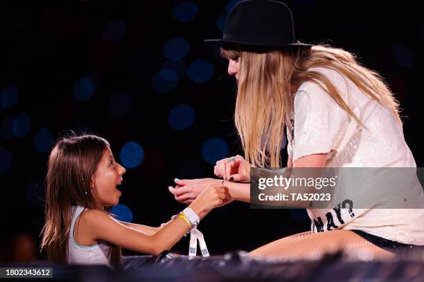 Young fan exchanges friendship bracelets with Taylor Swift as she performs onstage during "Taylor Swift | The Eras Tour" at Allianz Parque on...