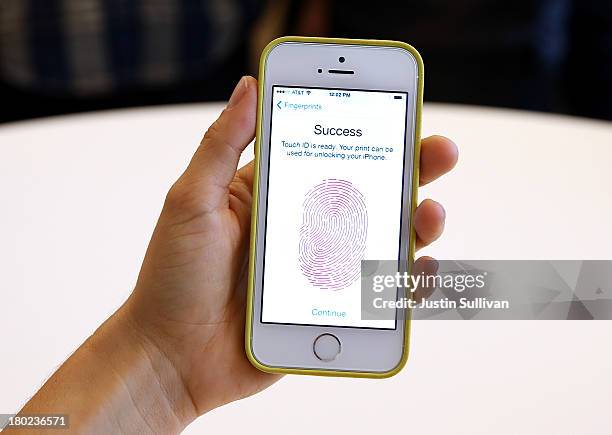 The new iPhone 5S with fingerprint technology is displayed during an Apple product announcement at the Apple campus on September 10, 2013 in...