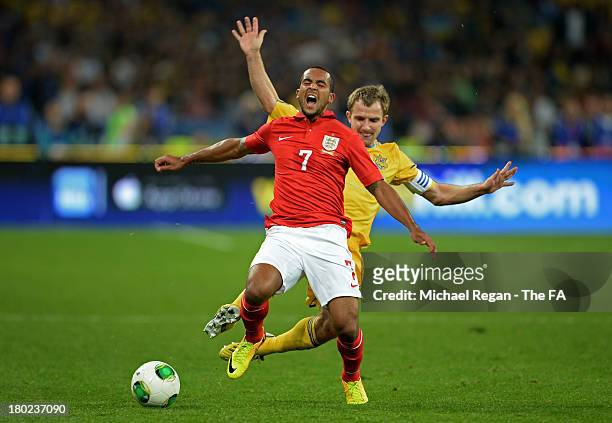 Theo Walcott of England cries out in pain after he is brought down by Oleksandr Kucher of Ukraine during the FIFA 2014 World Cup Qualifying Group H...