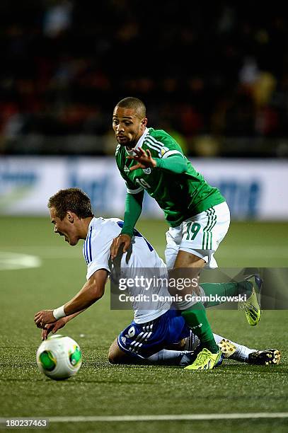 Sidney Sam of Germany challenges Hallur Hansson of Faeroe Islands during the FIFA 2014 World Cup Qualifier match between Faeroe Islands and Germany...