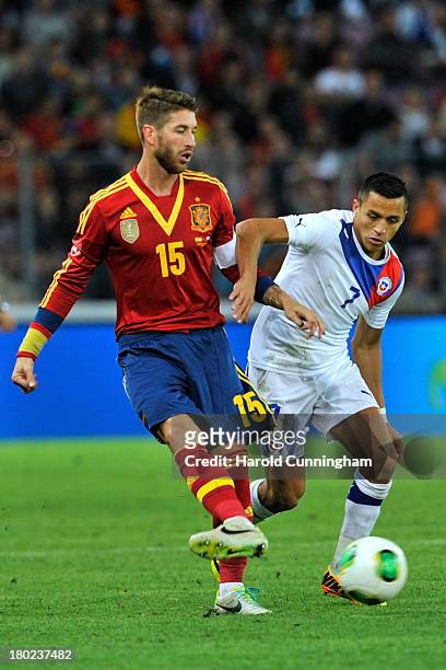 Sergio Ramos of Spain and Alexis Sanchez of Chile compete for the ball during the Spain v Chile international friendly at Stade de Geneve on...