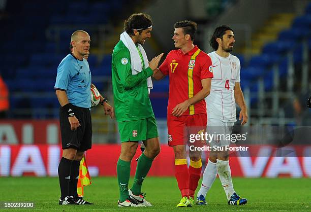 Wales player Gareth Bale shares a joke with Serbia goalkeeper Vladimir Stojkovic afer the FIFA 2014 World Cup Qualifier Group A match between Wales...
