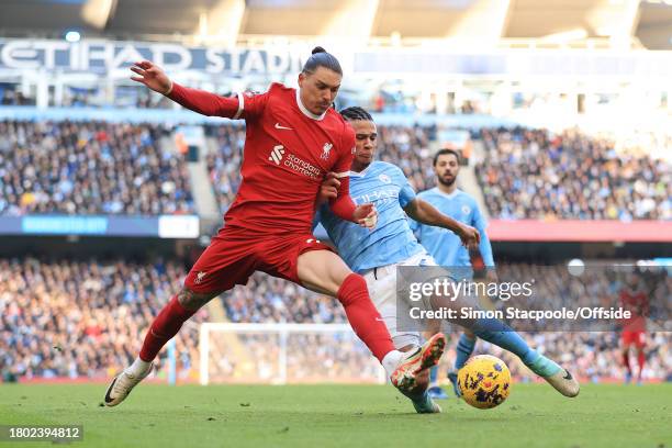 Nathan Ake of Manchester City tackles Darwin Nunez of Liverpool during the Premier League match between Manchester City and Liverpool FC at Etihad...