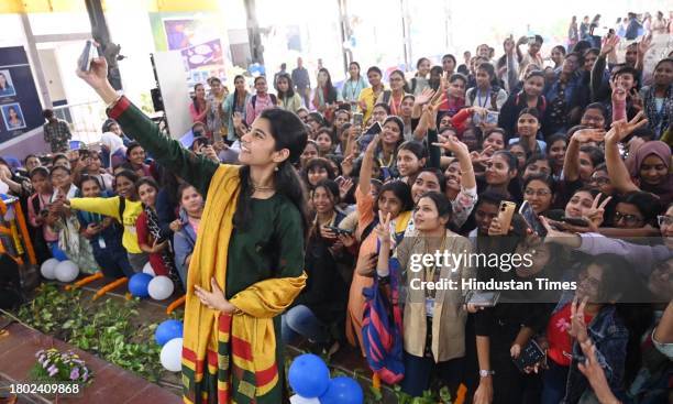 Brand Ambassador of Election Commission of India, Maithili Thakur taking selfie with students during youths voter awareness campaign at Magadh Mahila...