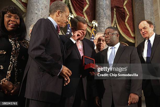 Speaker of the House John Boehner wipes away a tear while presenting the Congressional Gold Medal to Dr. Lawrence Pijeaux of the Birmingham Civil...