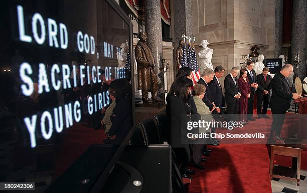 Bipartisian group of Congressional leaders bow their heads in prayer during a ceremony to posthumously award the Congressional Gold Medal to the four...