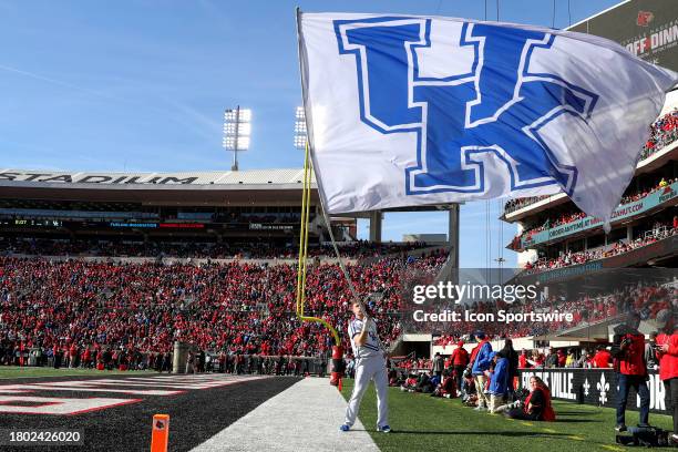 Kentucky Wildcats cheerleader waves the Kentucky flag after a Wildcats touchdown during the college football game between the Kentucky Wildcats and...