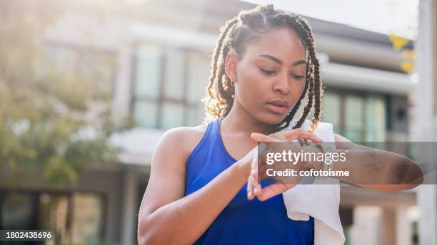 woman using smart watch before running - intelligence stock pictures, royalty-free photos & images