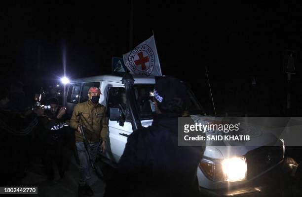 An International Red Cross vehicle reportedly carrying hostages released by Hamas drives towards the Rafah border point with Egypt ahead of their...