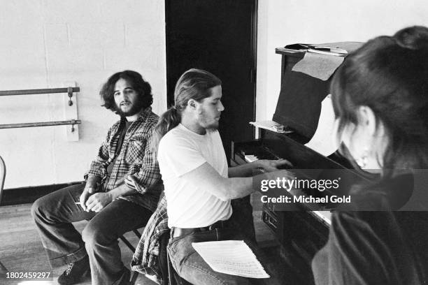 Cast of 'Lemmings' actor John Belushi, Paul Jacobs, and Alice Playten, obscured, rehearsing in a rehearsal hall in New York City, circa 1973.