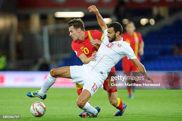 Team captain Aaron Ramsey of Wales is tackled by Ivan Radovanovic of Serbia during the FIFA 2014 World Cup Qualifier Group A match between Wales and...