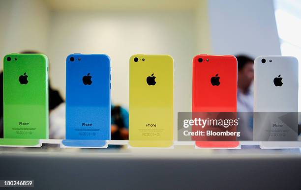The new Apple Inc. IPhone 5C sit on display during a product announcement in Cupertino, California, U.S., on Tuesday, Sept. 10, 2013. Apple Inc....