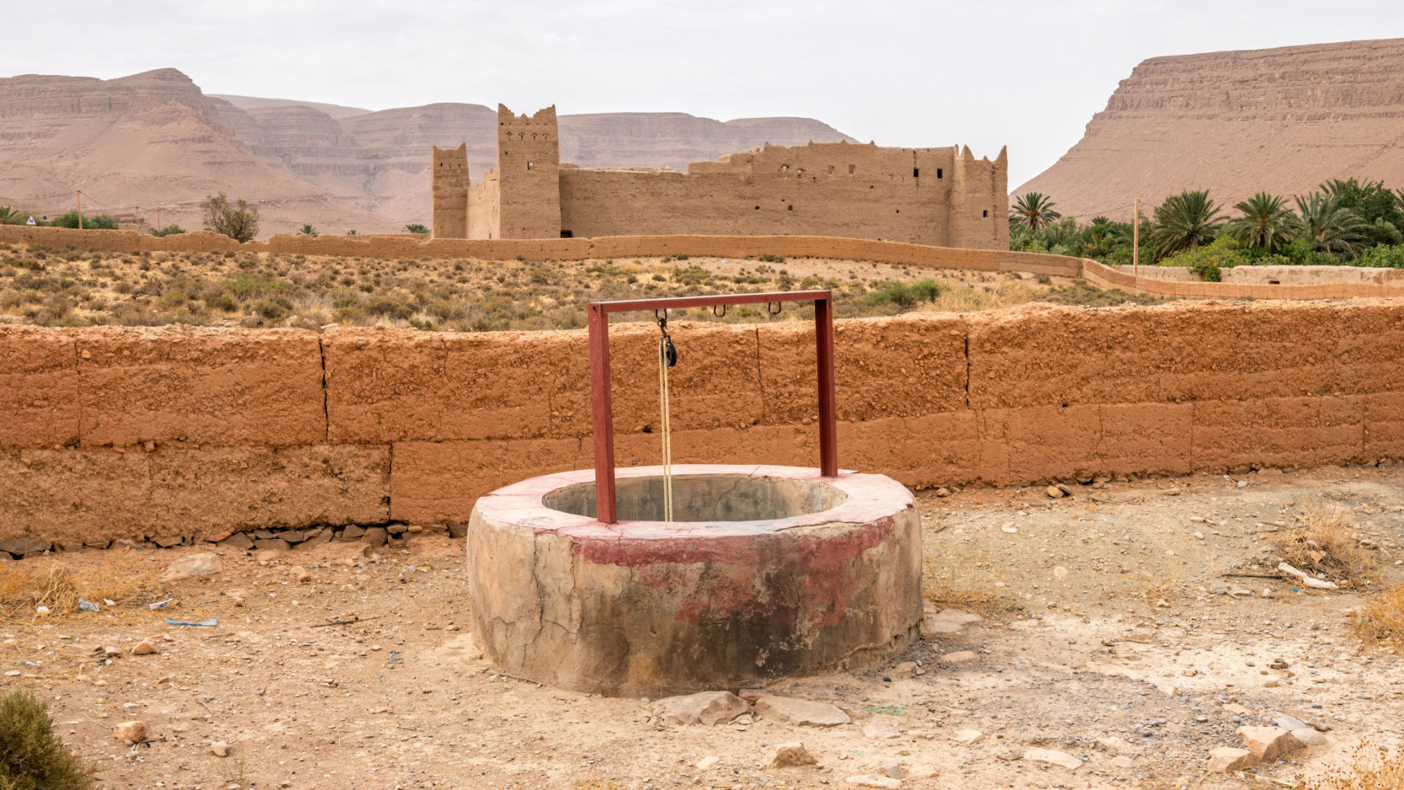 A water well with a traditional Moroccan fortress, Morocco A water well with a traditional Moroccan fortress, Morocco