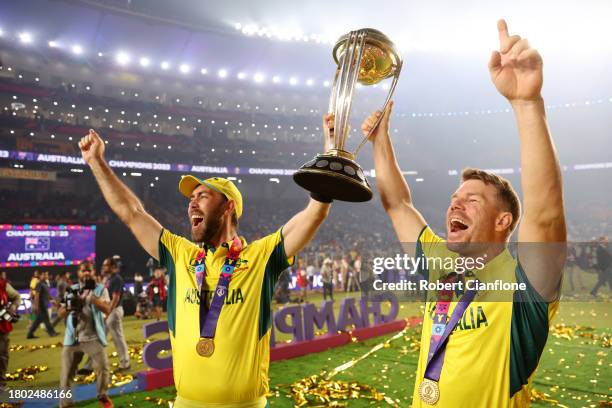 Glenn Maxwell and David Warner of Australia poses with the ICC Men's Cricket World Cup Trophy following the ICC Men's Cricket World Cup India 2023...