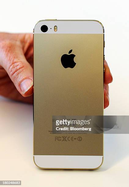 The new Apple Inc. IPhone 5S is displayed for a photograph during a product announcement in Cupertino, California, U.S., on Tuesday, Sept. 10, 2013....