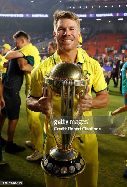 David Warner of Australia poses with the ICC Men's Cricket World Cup Trophy following the ICC Men's Cricket World Cup India 2023 Final between India...