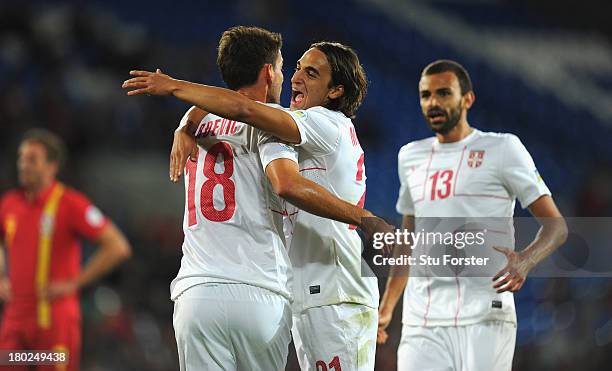 Serbia forward Filip Dordevic celebrates with Lazar Markovic after scoring the opening goal during the FIFA 2014 World Cup Qualifier Group A match...