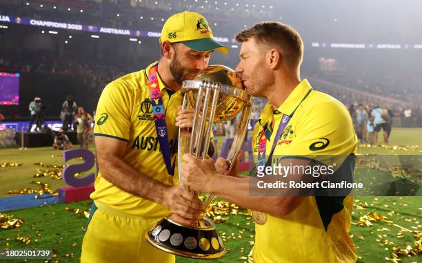 Glenn Maxwell and David Warner of Australia poses with the ICC Men's Cricket World Cup Trophy following the ICC Men's Cricket World Cup India 2023...