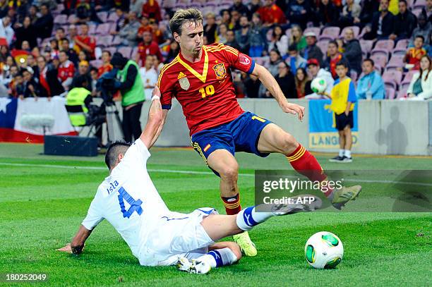Spain's Igniacio Montreal fights for the ball with Chile's Mauricio Isla on September 10, 2013 during an international friendly football match at the...