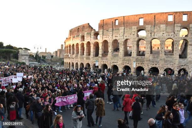 Protesters walk past the Colosseum during a demonstration against violence on women in Rome, Italy, on November 25, 2023. Hundred of thousands people...