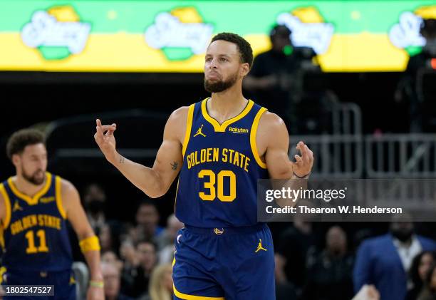 Stephen Curry of the Golden State Warriors reacts after making a three-point shot against the Oklahoma City Thunder during the first half of an NBA...