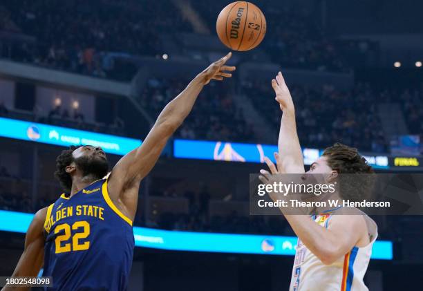 Andrew Wiggins of the Golden State Warriors blocks the shot of Josh Giddey of the Oklahoma City Thunder during the first half of an NBA basketball...