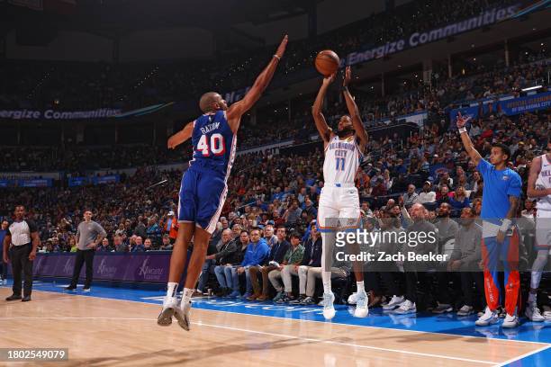 Isaiah Joe of the Oklahoma City Thunder shoots a three point basket during the game against the Philadelphia 76ers on November 25, 2023 at Paycom...