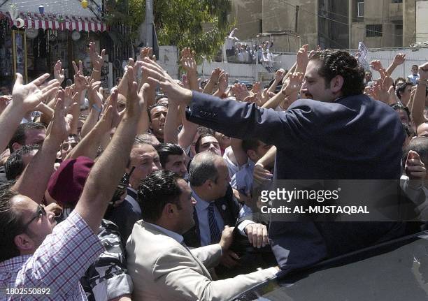Saad Hariri, the son of slain former Lebanese premier Rafiq Hariri, is greeted by the faithful following the Friday prayer in Beirut 20 May 2005. A...